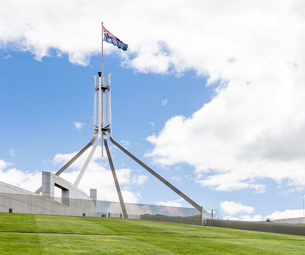 Photo of Australian Parliament building on a green lawn