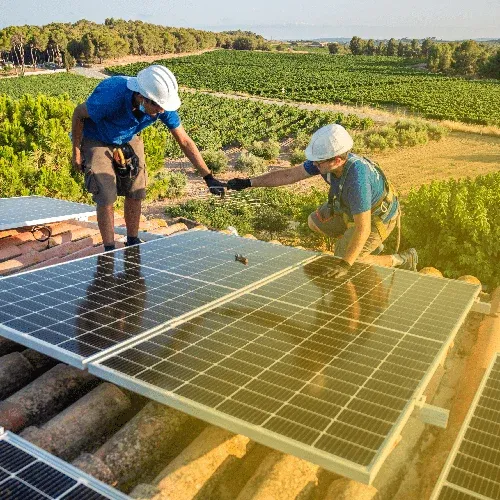 two people installing solar panels