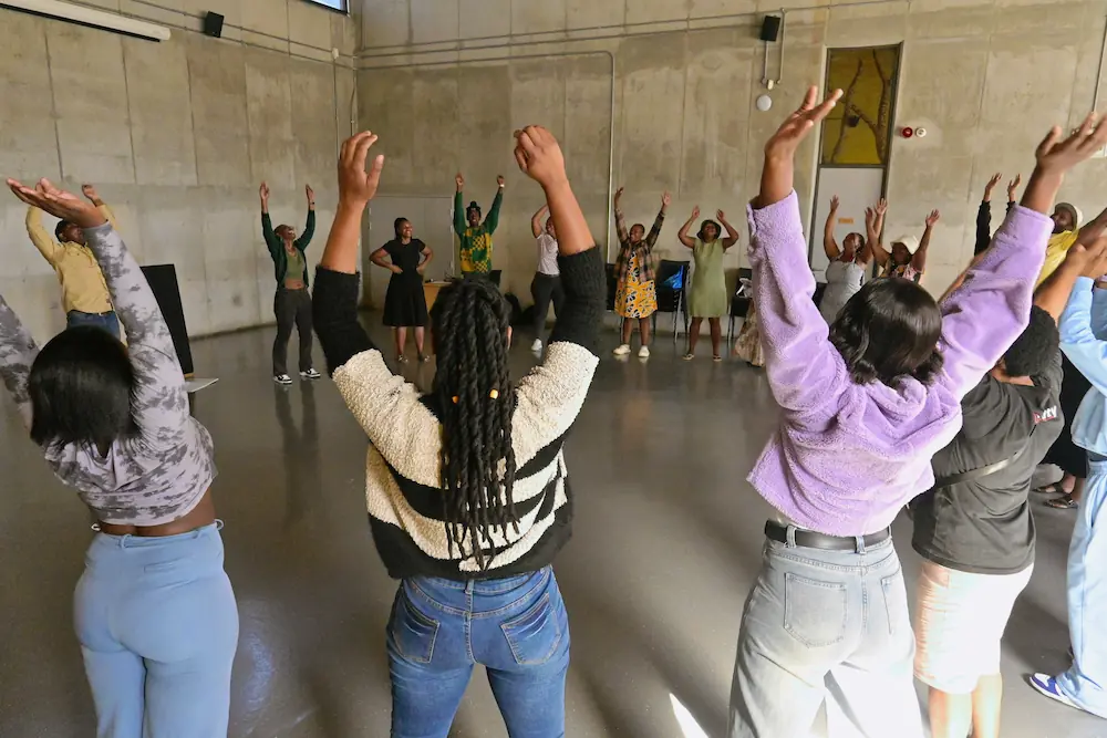 group raising arms in air during activity