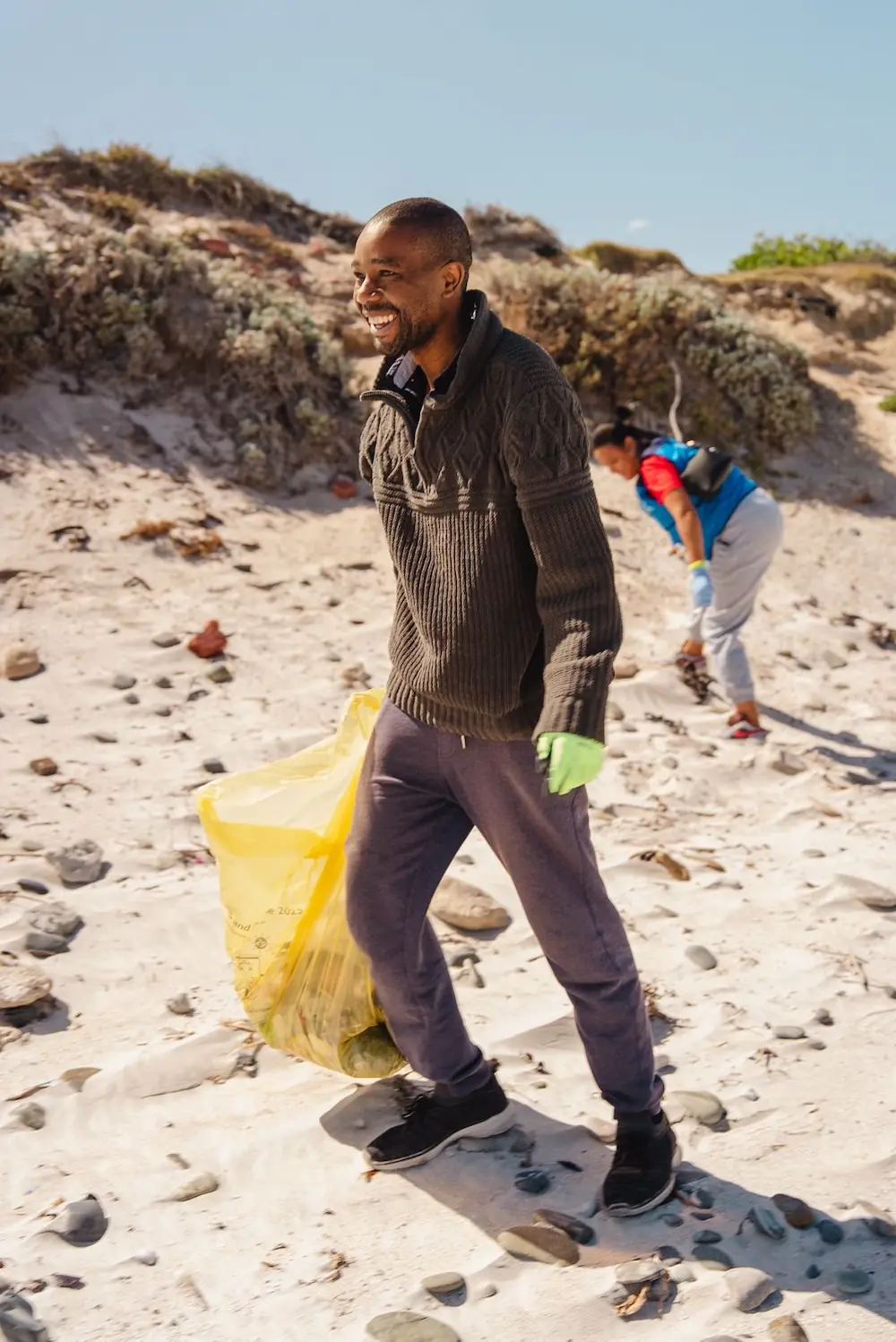 khotso picking up trash on a beach