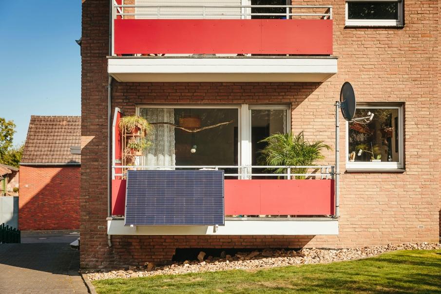 Small plug-in solar panels mounted on apartment balcony.