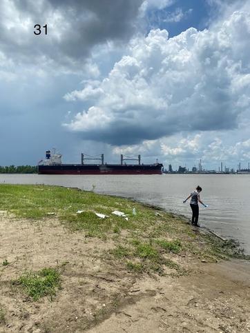 Person standing by edge of Mississippi river