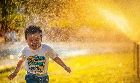 Child in Sprinkler
