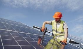 Solar technician installing solar panels