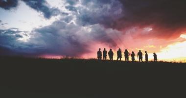 Group of people on ridge at dawn