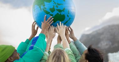 young people holding up a globe