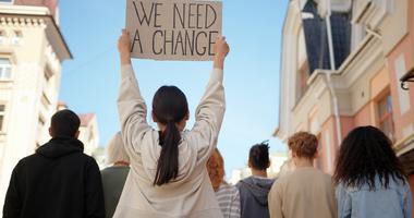 Student protestor holding up a sign