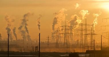 active smoke stacks on a yellow hazy skyline