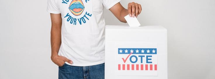Person puts ballot in ballot box 