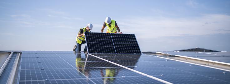 Image of workers installing solar panels.