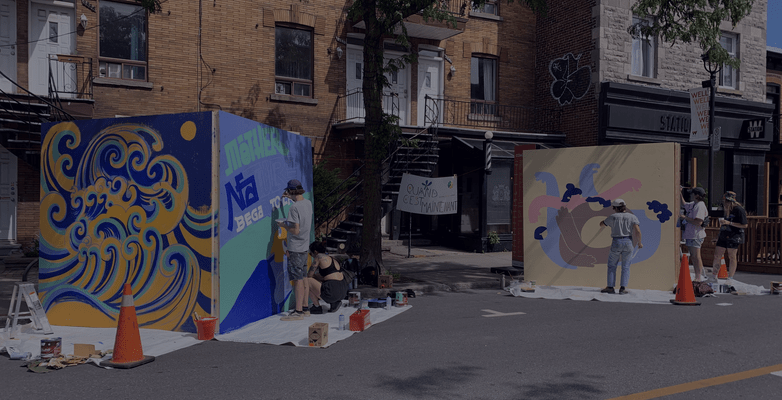 People painting a mural on a building