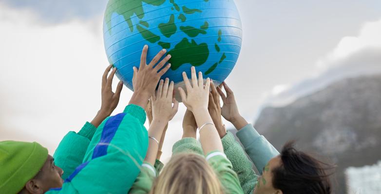 young people holding up a globe