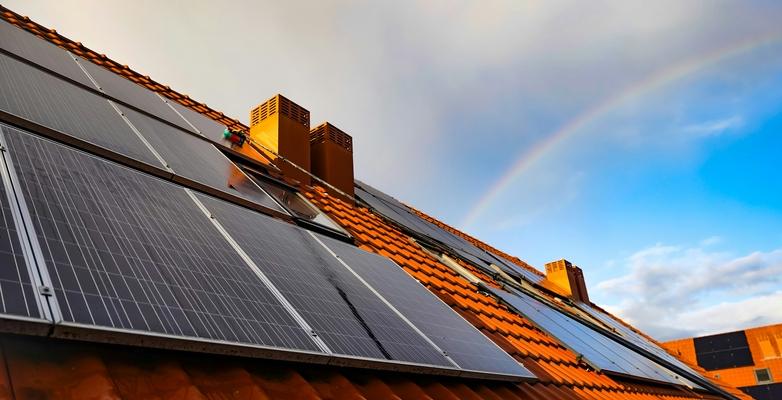 rainbow behind solar panel