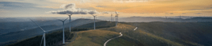 Turbines in a field on a hill at Sunrise