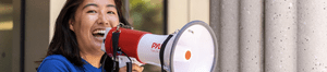 woman in blue shirt speaking into megaphone